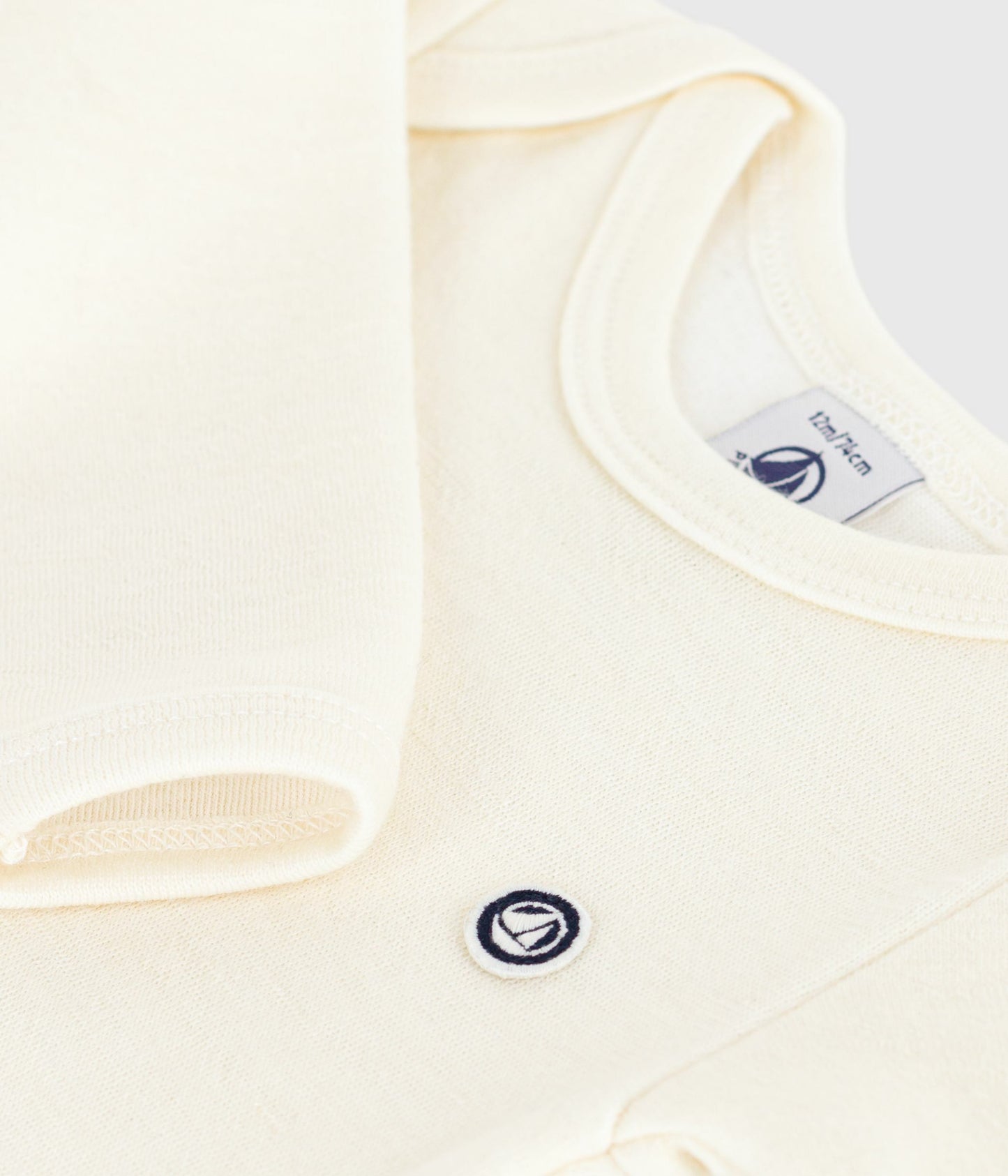 Heldragt i råhvid uld til baby