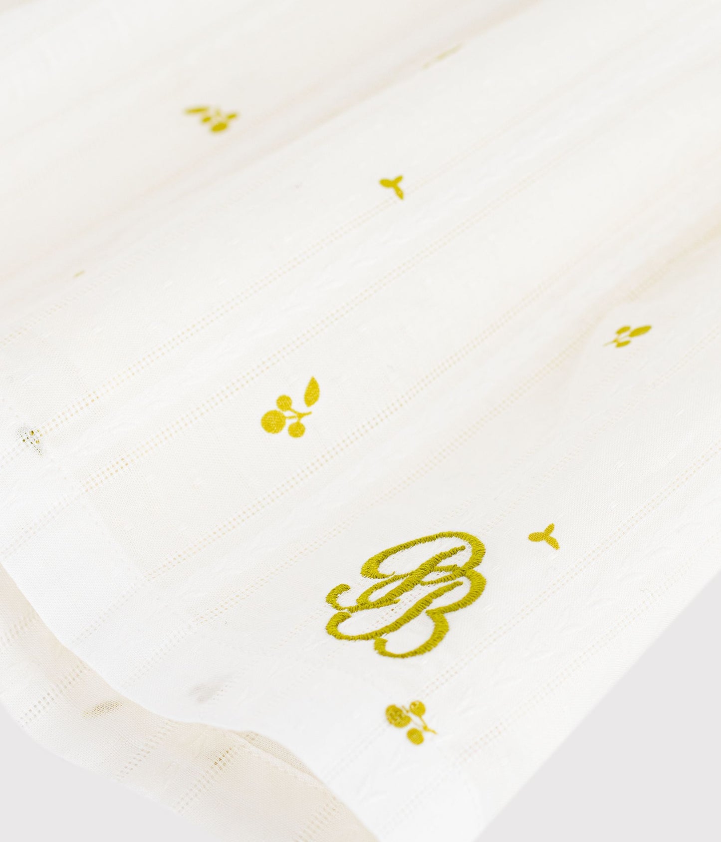 Hvid bomuldskjole til baby med tryk og kant i Olivengrøn